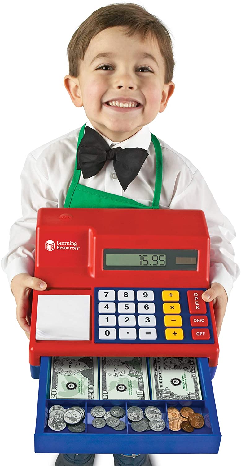 Child holding a red Cash Register with calculator buttons, pretend money, and coins, encouraging imaginative play.