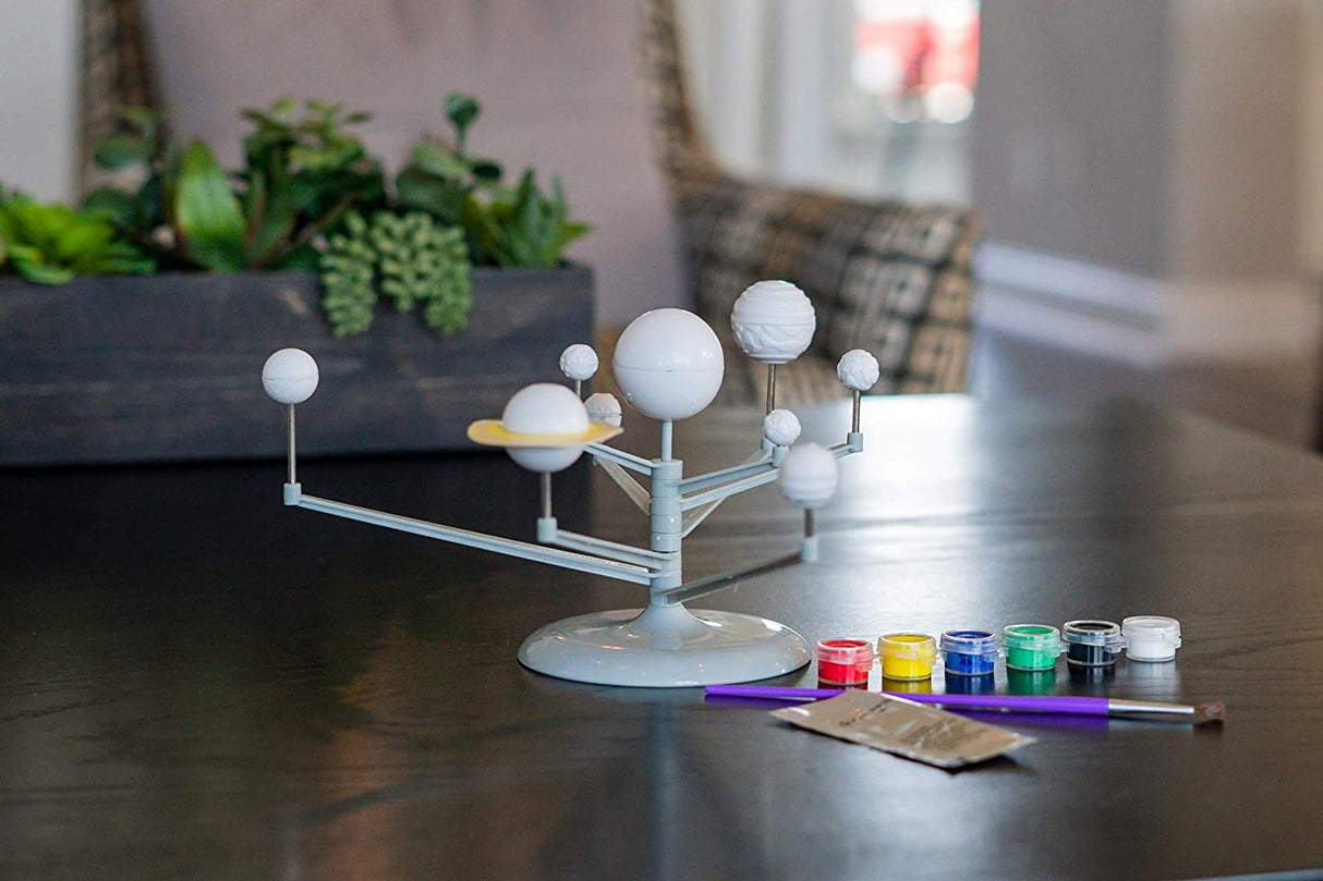 Solar System Planetarium on table with paintbrushes and paint set ready for assembly and creative fun.