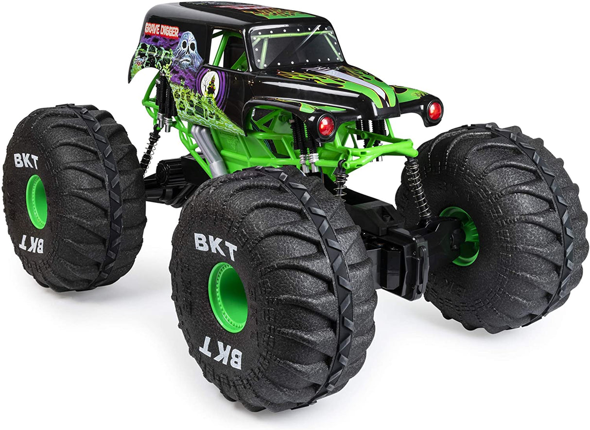 HUGE RC Grave Digger monster truck with oversized BKT tires, green chassis, and authentic Monster Jam graphics.