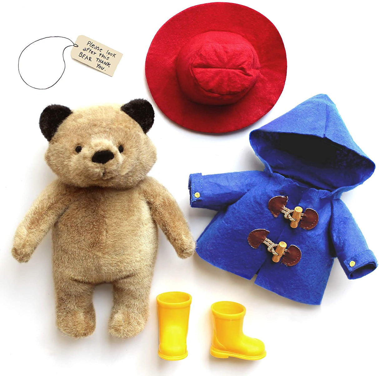 Paddington Bear plush with red felt hat, blue hooded coat, yellow boots, and "Please Look After This Bear" tag.