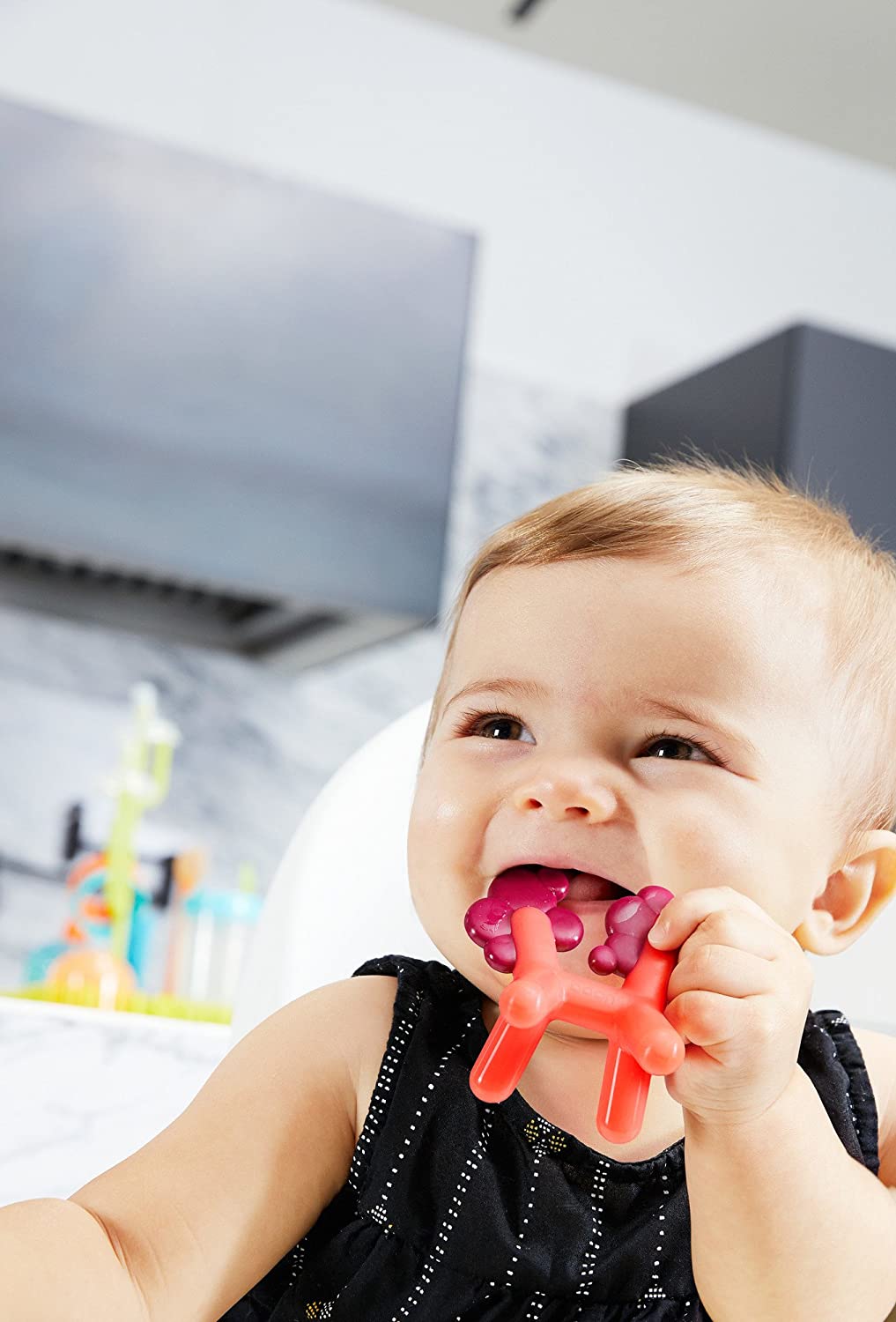 Baby chewing on a silicone teether PRANCE designed with multiple textures to soothe gums and easy for little hands to hold