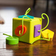OombeeCube with six colorful, textured silicone shapes tethered for safe, tactile exploration and teething fun for babies.