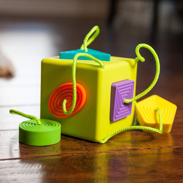OombeeCube with six colorful, textured silicone shapes tethered for safe, tactile exploration and teething fun for babies.