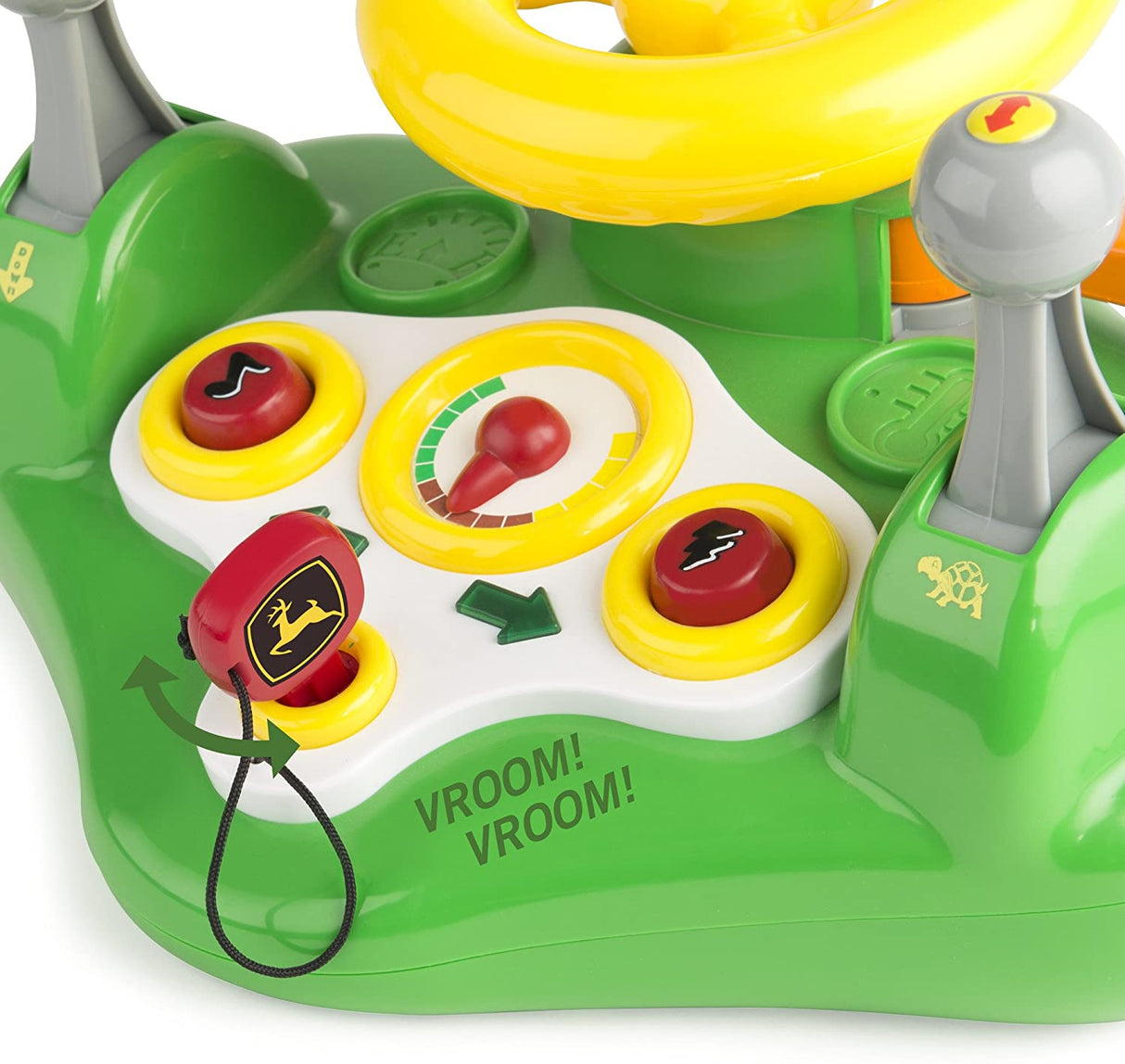 Close-up of the interactive dashboard with buttons and gears on the John Deere Busy Driver toy tractor.