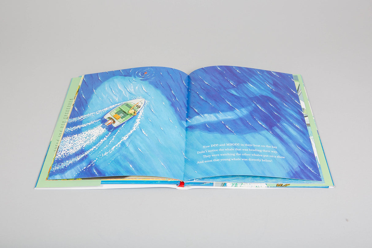 Down to the Sea With Mr Magee shows Mr. Magee and dog Dee sailing near a playful whale in vibrant ocean hues.
