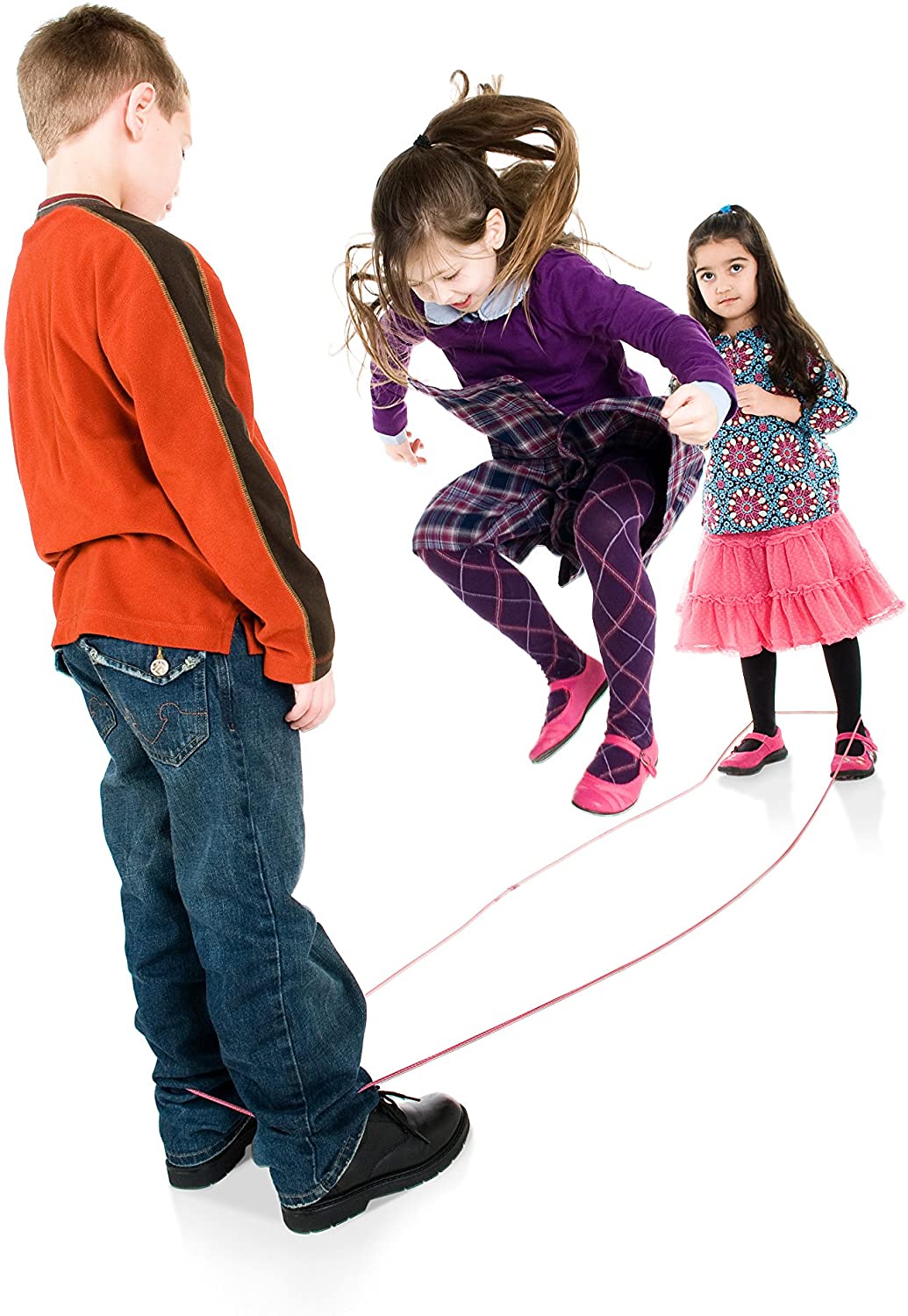 Three children playing with a red elastic Chinese Jump Rope in a bright, fun indoor setting.