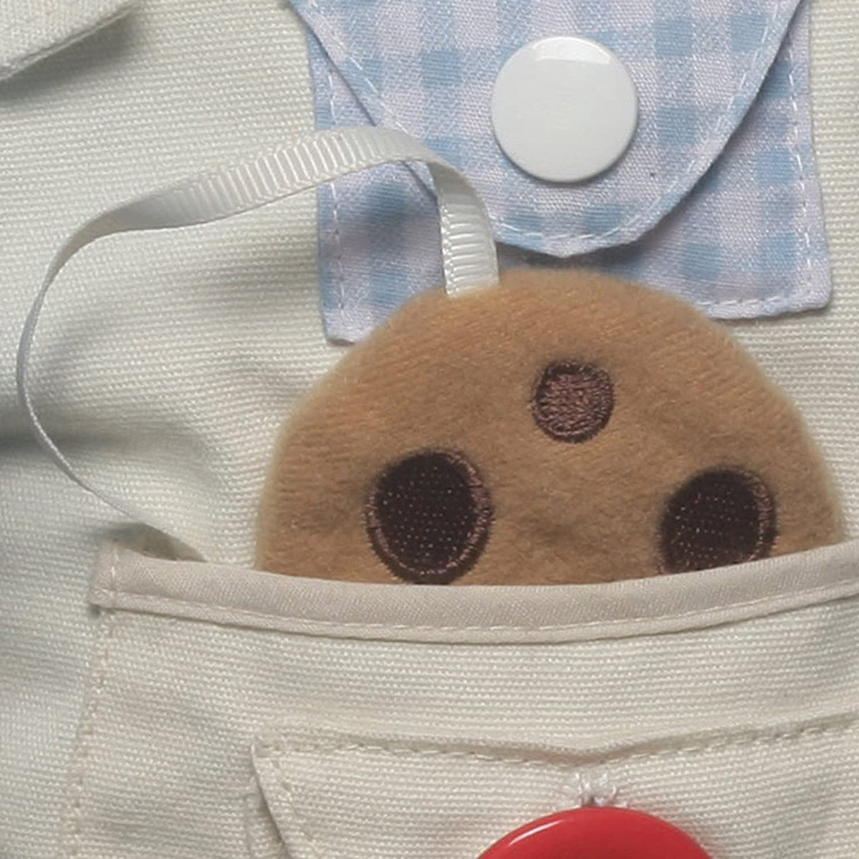 Teach-Me Cookie Monster plush pocket detail with button and fabric showing educational dressing skills toy.