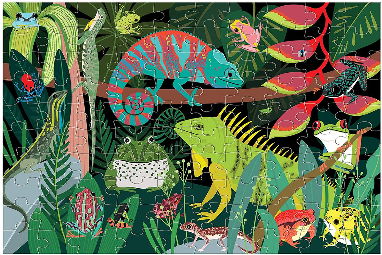 100pc Frogs & Lizards Glow Puzzle showing colorful amphibians and reptiles in a vibrant jungle scene.