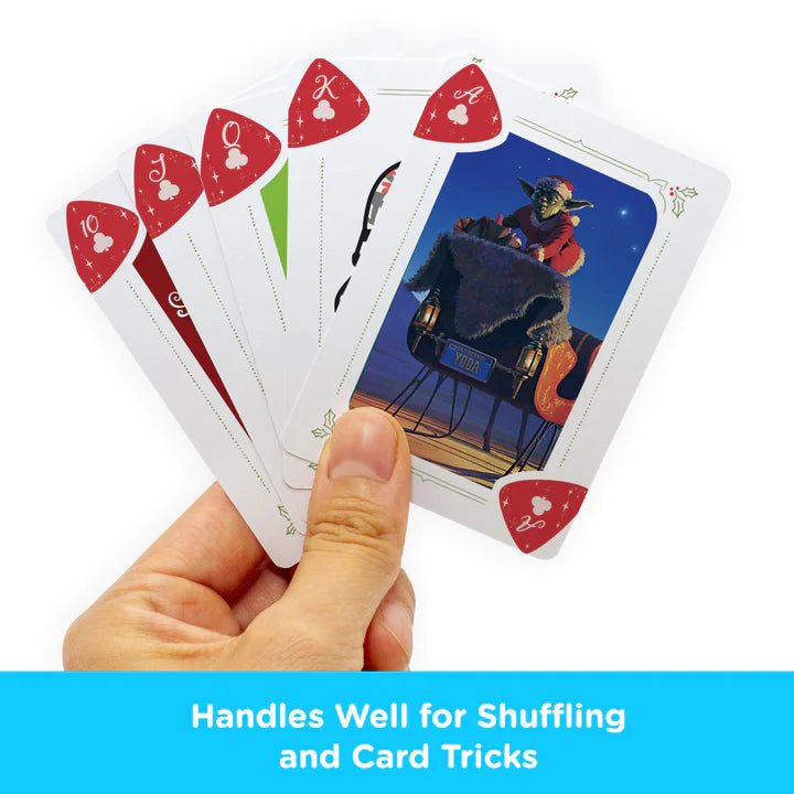 Hand holding Star Wars Christmas Playing Cards featuring Yoda and festive holiday designs for card games.