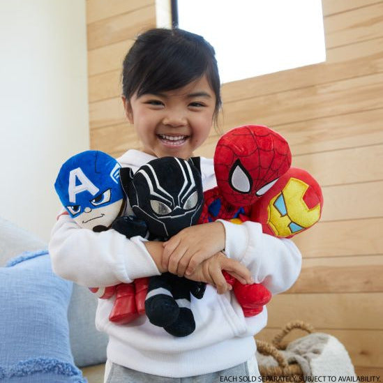 Smiling child holding four Marvel Plush Character figures including Captain America, Black Panther, Spider-Man, and Iron Man.