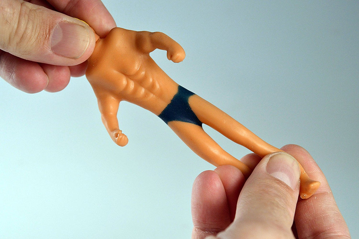 Hands stretching the World's Smallest Stretch Armstrong toy, showing its flexible arms and legs.