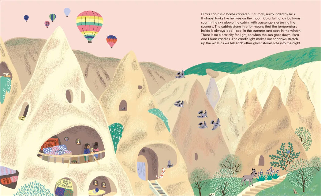 My Perfect Cabin" illustration of unique rock homes with hot air balloons in a colorful mountainous landscape for children.