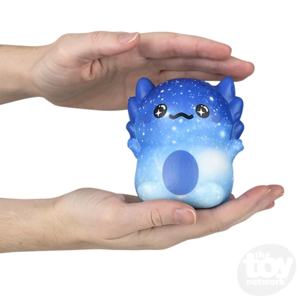 Squishy Axolotl 4in held between hands, blue starry pattern, soft and squeezable toy for kids ages 3 and up.