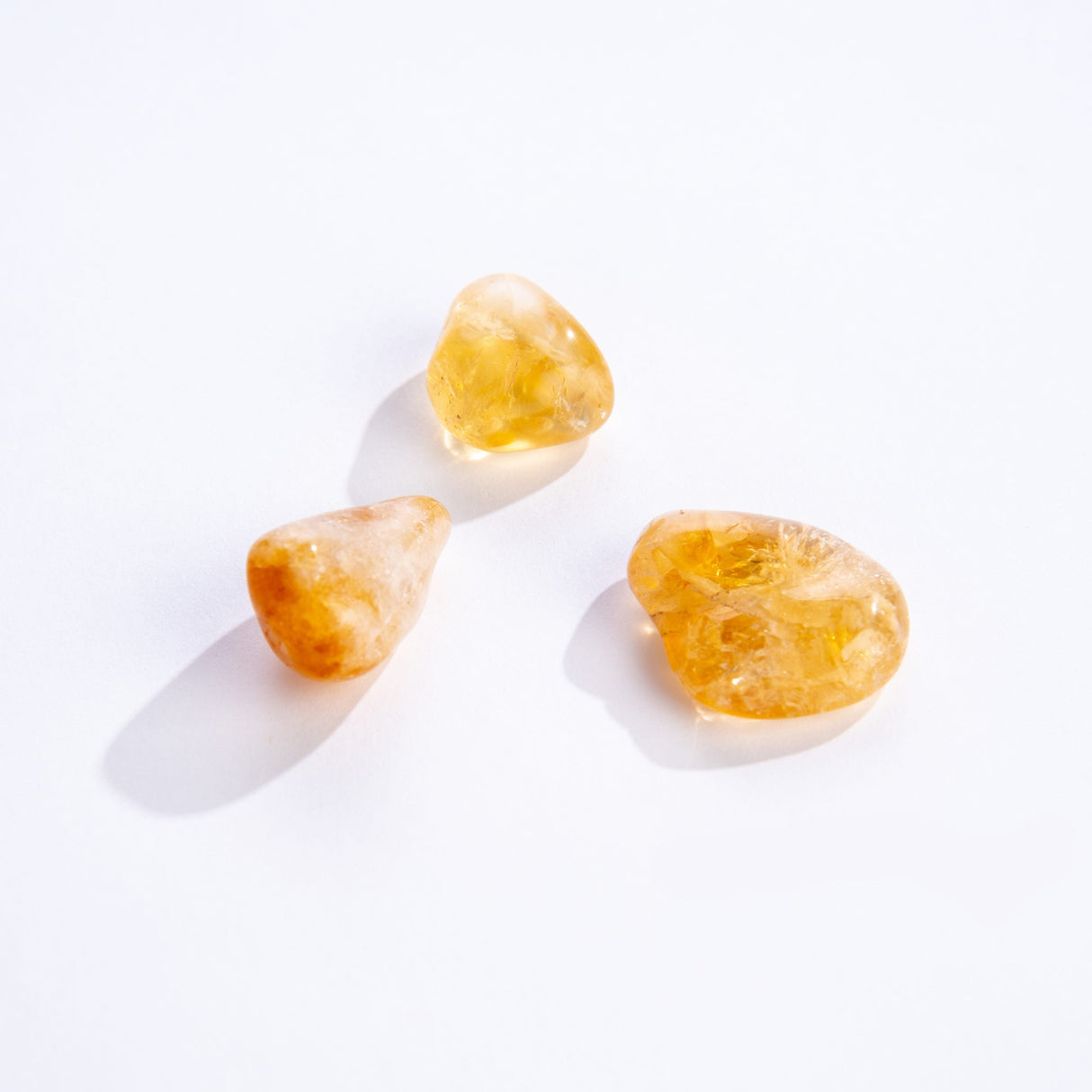 Rock | Tumbled Citrine showing three golden-yellow quartz stones, 1 to 2 inches, known for optimism and clarity.