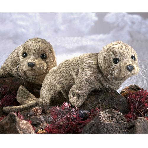 Harbor Seal Puppet featuring two soft, realistic seals with black eyes and whiskers on rocky ocean floor set.