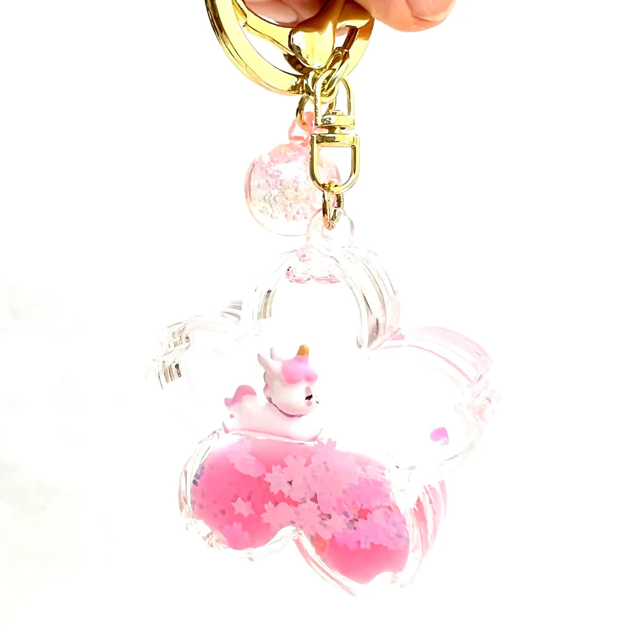 Unicorn Flower Keychain with a pink flower-shaped pendant and a small unicorn inside, attached to a gold clip and keyring.