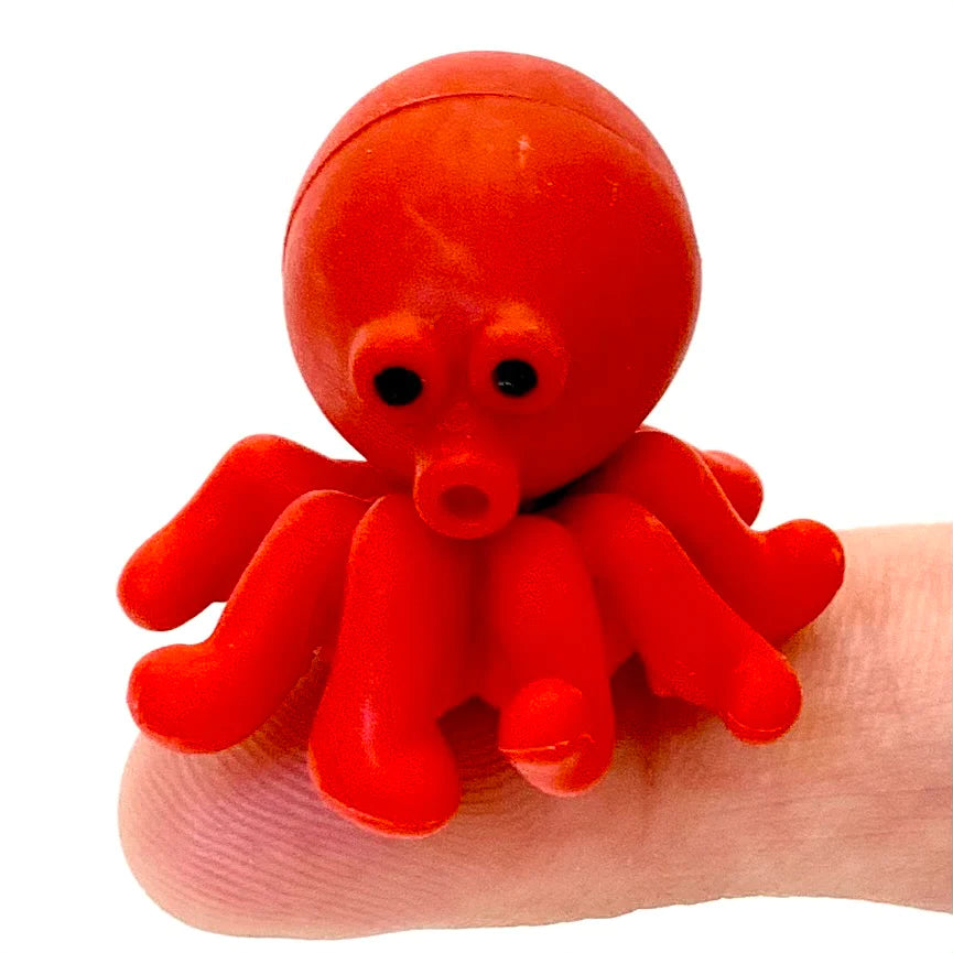 Japanese Eraser Sea Friend adorable red octopus eraser sitting on a fingertip, perfect cute puzzle piece eraser.