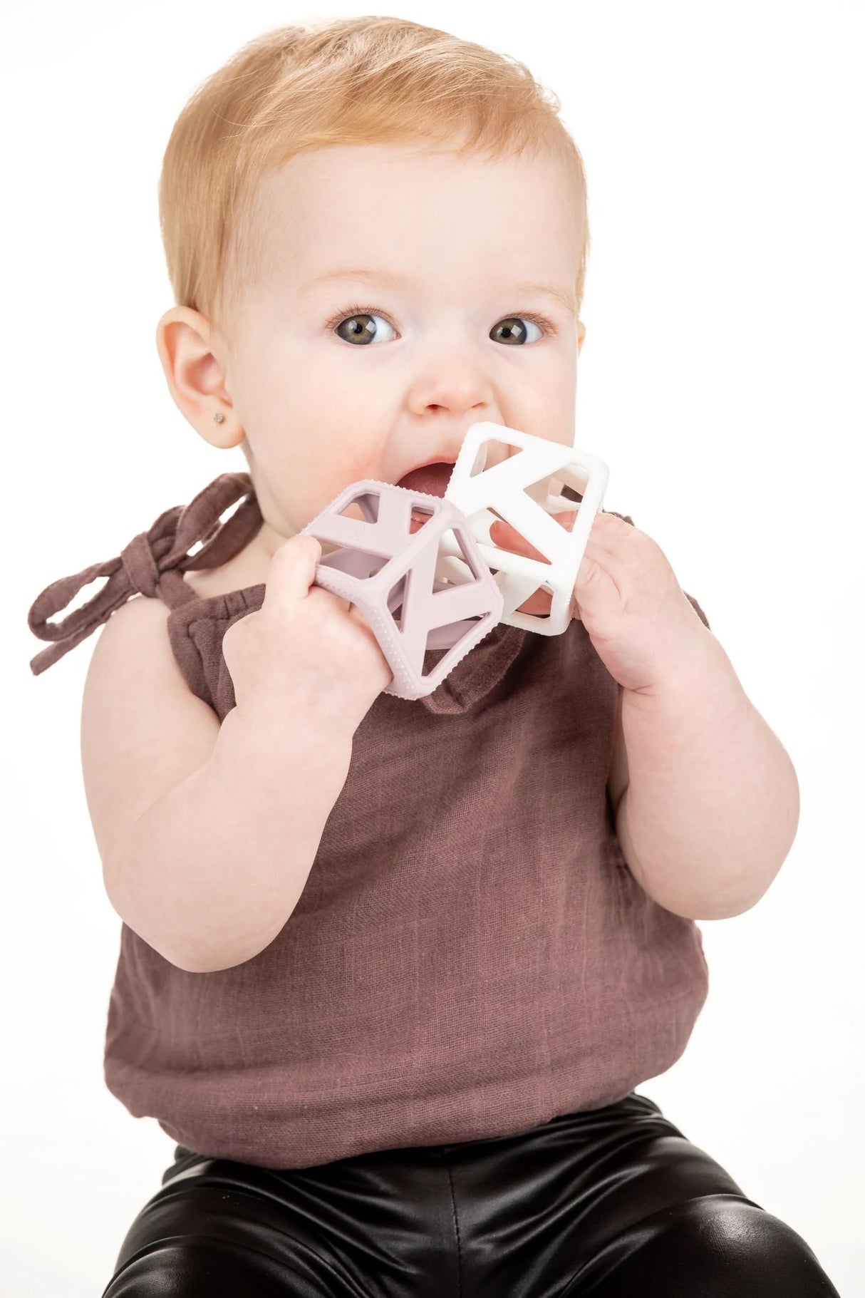 Baby chewing on Stack & Chew Pastel Cubes teething toy designed for safe, BPA-Free sensory play and motor skill development.