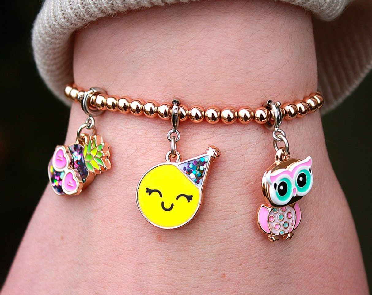 Gold Bead Stretch Bracelet with shiny round beads and colorful playful charms on wrist, perfect for stacking and fun style.
