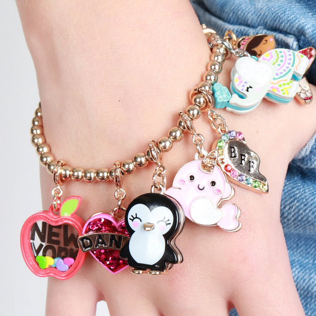 Gold Penguin Charm showing a cute enamel penguin charm on a beaded bracelet with colorful designs.