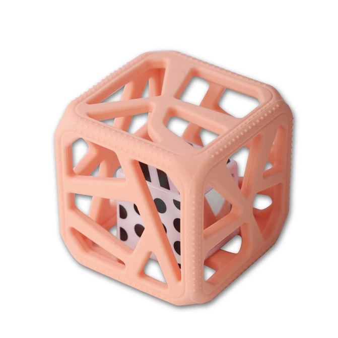 Chew Cube | Peachy Pink soft teether with textured edges and black-and-white patterned rattle for sensory stimulation.