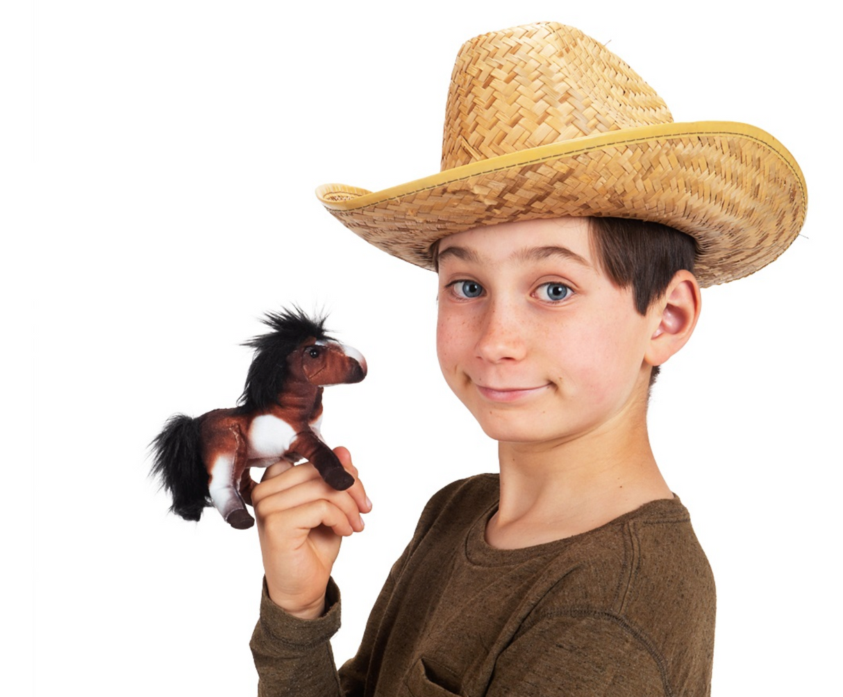 Boy wearing a straw hat holding a brown Horse Finger Puppet with black mane and tail, playing with it.