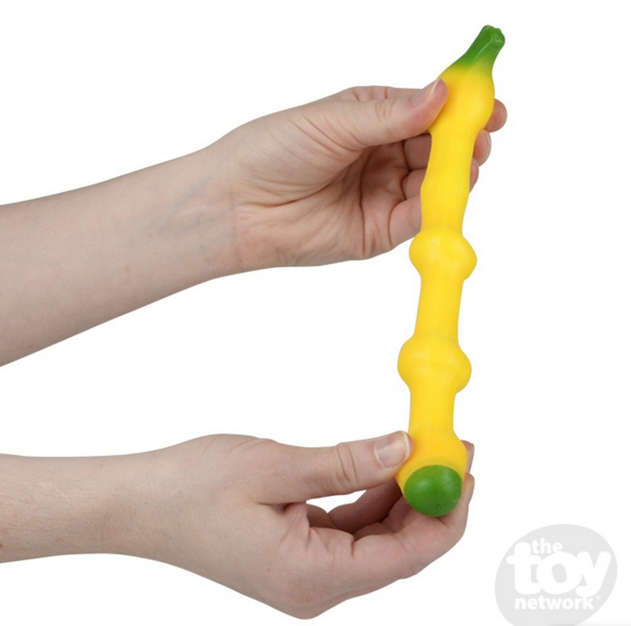 Hands holding and stretching the fun textured Stretch & Squeeze Banana fidget toy for stress relief and play.