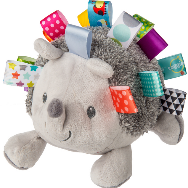 Taggies Heather Hedgehog Soft Toy with colorful ribbons, embroidered details, and a soft gray plush body, perfect for all ages.