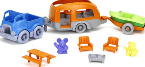 Green Toys RV Camper Set with blue truck, orange camper, green boat trailer, two chairs, picnic table, stove, and two characters.