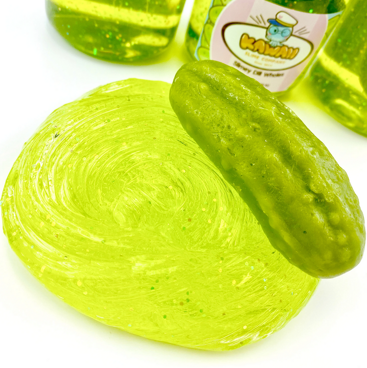 Shimmery Pickle Clear Slime with glitter and a realistic pickle eraser, stretchy and scented like a dill pickle.