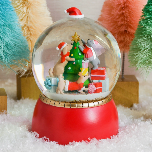 Cats & Dogs Snowglobe with hand-painted cats and dogs decorating a Christmas tree inside a glass globe with a red base.