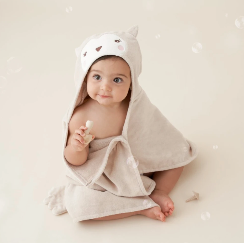Baby wrapped in soft Owl Hooded Towel with cute animal face, perfect for cozy bath time and drying off.
