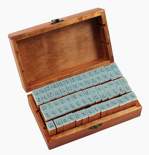 Letterpress Stamp Set featuring 70 vintage-style letter, number, and punctuation stamps in a rustic wooden box.