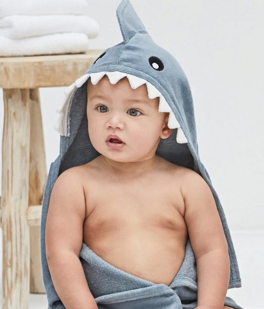 Baby wearing a cozy Hooded Bath Towel Shark with a cute shark face and fin, perfect for drying off after bath time.