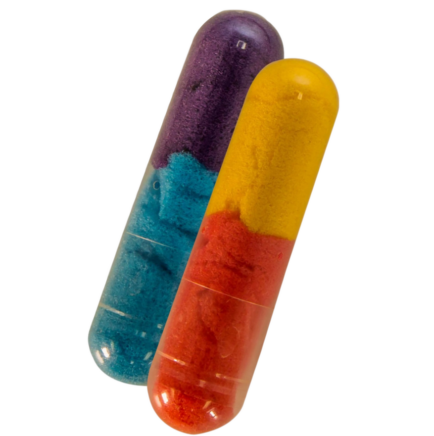 Two colorful Bath Beans Journey capsules containing sponge toys inside, ready to dissolve in bathwater.