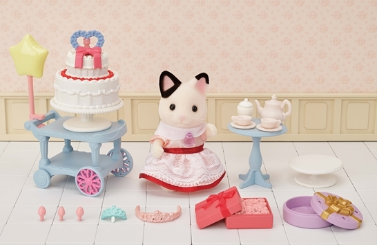 Party Time Playset with Tuxedo Cat Lily in party dress, two-tier cake, presents, tea set, and star balloon on cart.