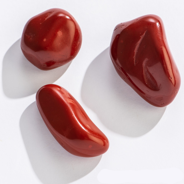 Rock | Tumbled Red Jasper showing smooth deep coppery red stones with natural striations and unique patterns.