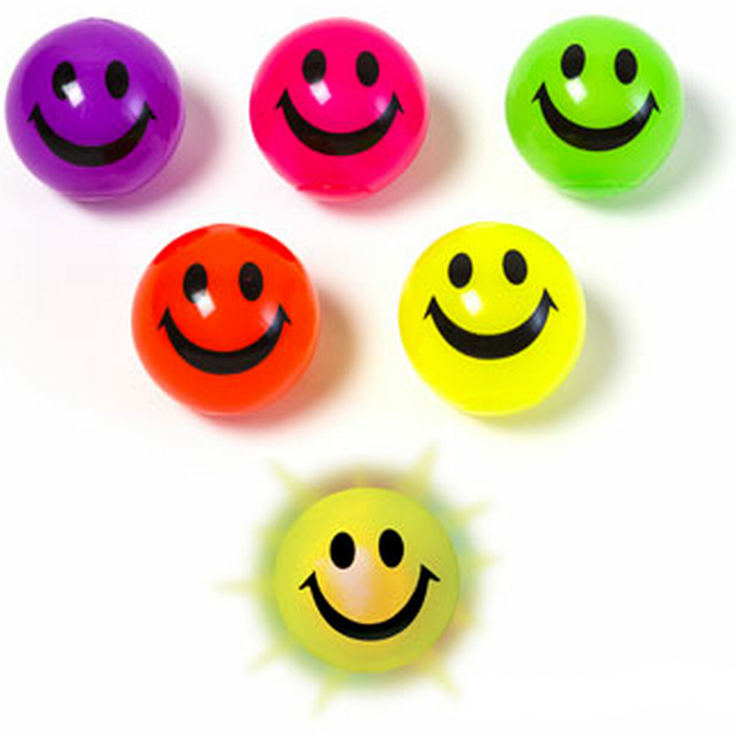 Bright assorted colored bouncy balls with smiling faces, featuring the Bouncy Ball | Light Up Smiley product.