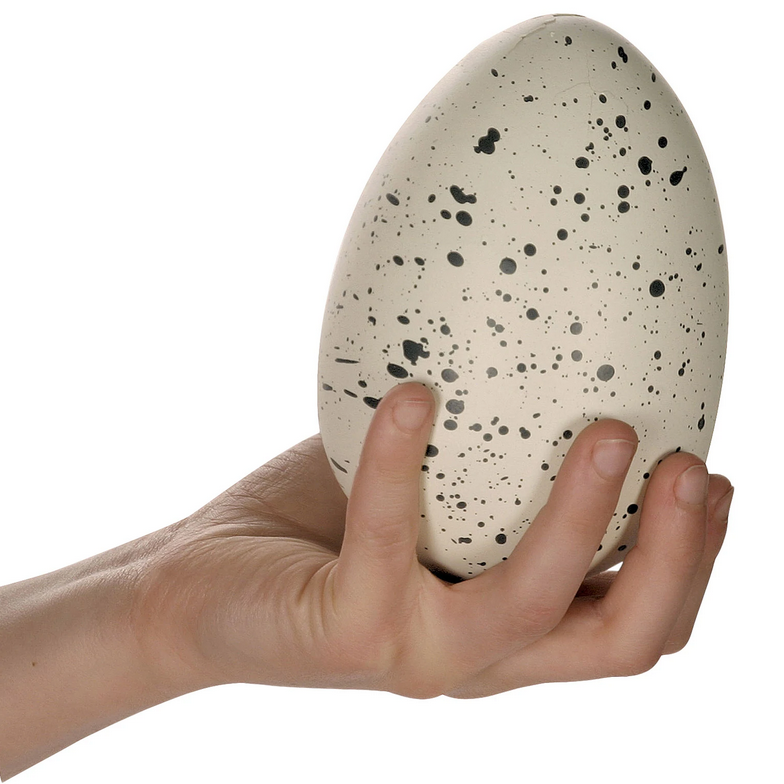 Hand holding a speckled egg toy from the Ginormous Hatchin' Grow Dino product for kids to hatch and grow.