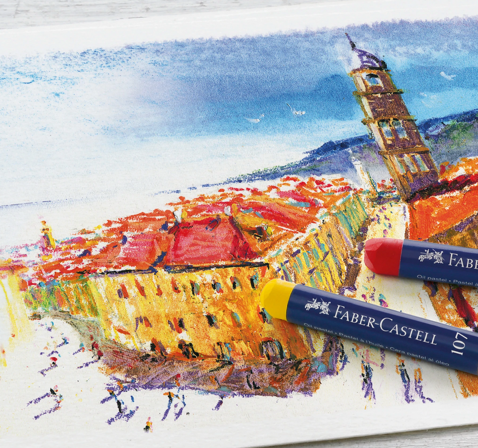 Oil Pastels showing vibrant color opacity and smooth texture with red and yellow pastels on a colorful cityscape artwork.