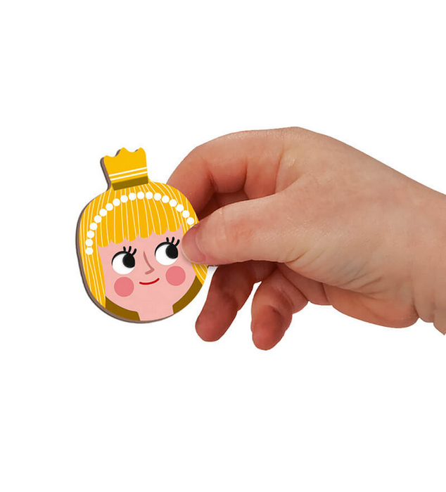 Hand holding a magnetic princess face piece from the MagnetiBook Fairy Tales educational magnetic toy set.