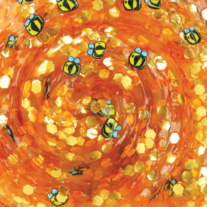 Close-up of vibrant amber and gold Honey Hive Thinking Putty swirled with sparkling honeycomb and buzzing bees, Trendsetters Honey Hive Thinking Putty.