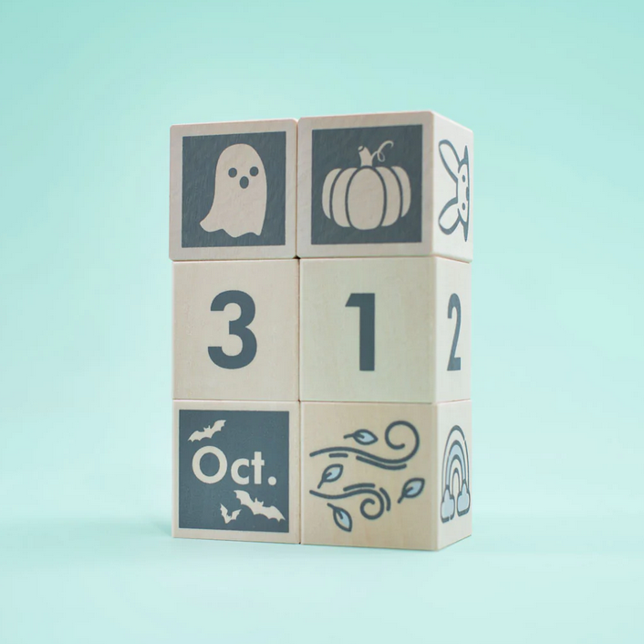 Perpetular Calendar Blocks showing October 31 with Halloween and autumn symbols on sustainable wooden cubes.