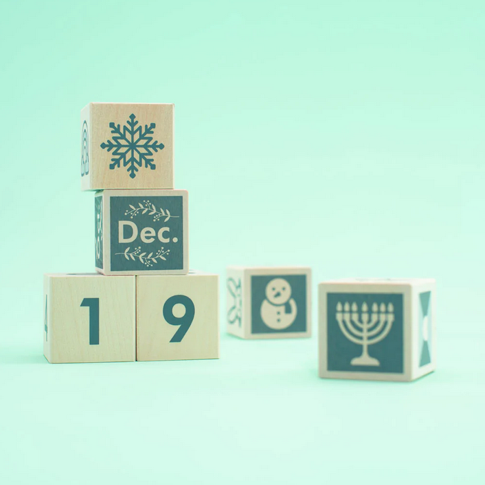 Perpetular Calendar Blocks showing December 19 with winter and holiday symbols on sustainable wooden cubes.