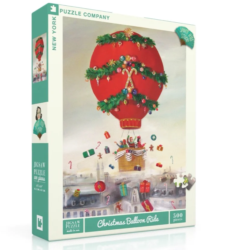 500pc Christmas Balloon Ride Puzzle featuring a festive hot air balloon tossing Christmas gifts over a winter town.