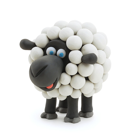 Hey Clay Animals black and white sheep figurine made from soft, lightweight clay with blue eyes and sculpted details.