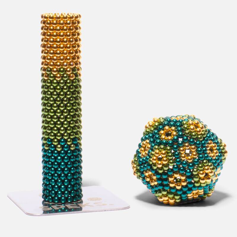 Speks. Gradient. Inspire. showing colorful magnetic balls stacked and shaped as a patterned stress-relief desk toy.
