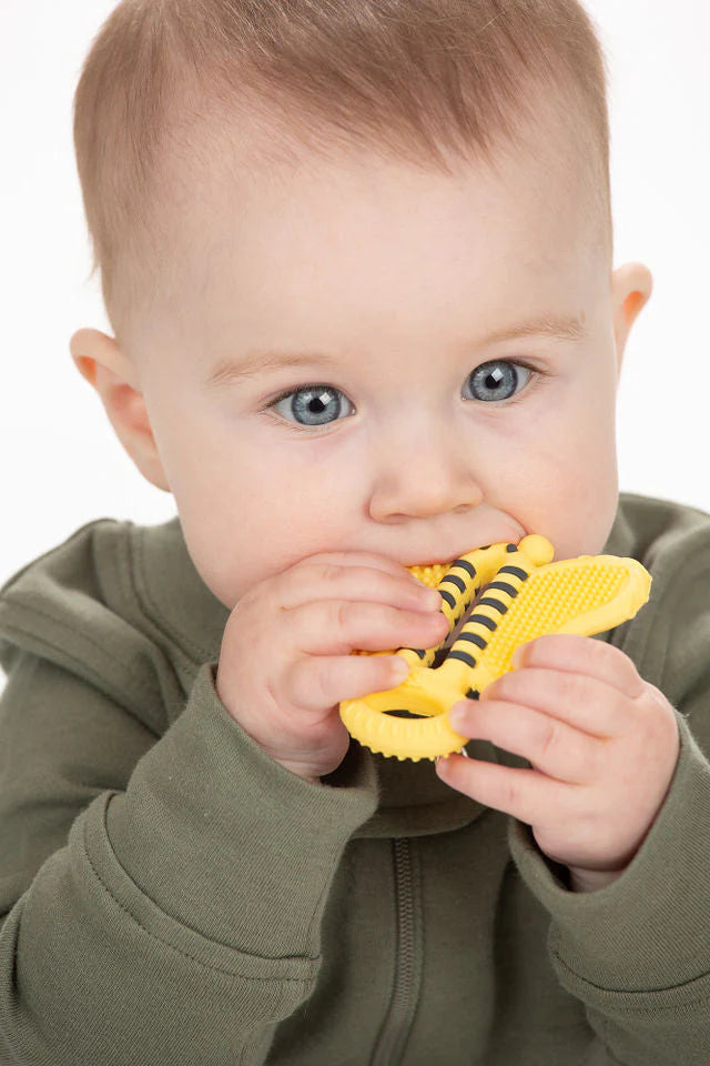 Baby chewing on a yellow Toothbrush Teether | Bee Brush designed for soothing gums and promoting oral hygiene.