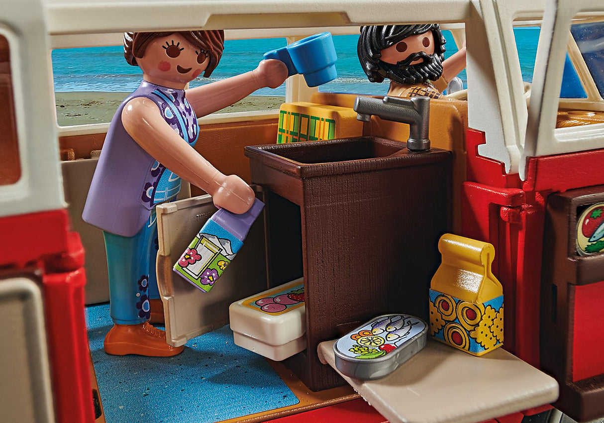 Volkswagen T1 Camp Bus interior showing mini-kitchen with sink, fridge, and PLAYMOBIL figures enjoying camping adventure.