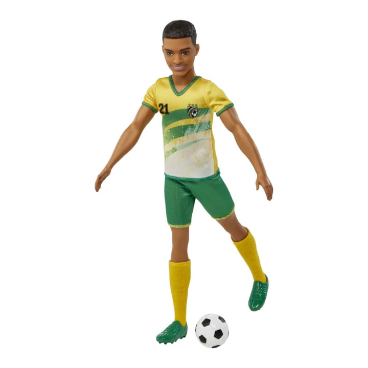 Barbie Ken Soccer #21 doll wearing yellow and green uniform with soccer ball accessory in a kicking pose.
